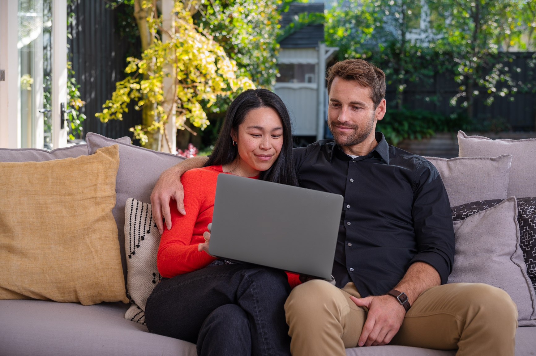 A couple exploring their home loan options together on a laptop